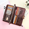 A brown genuine leather vintage clutch wallet is shown open, displaying various cards and cash inside.