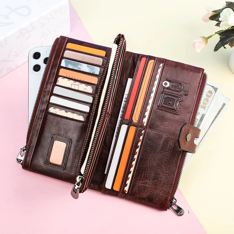 A brown genuine leather vintage clutch wallet is shown open, displaying various cards and cash inside.