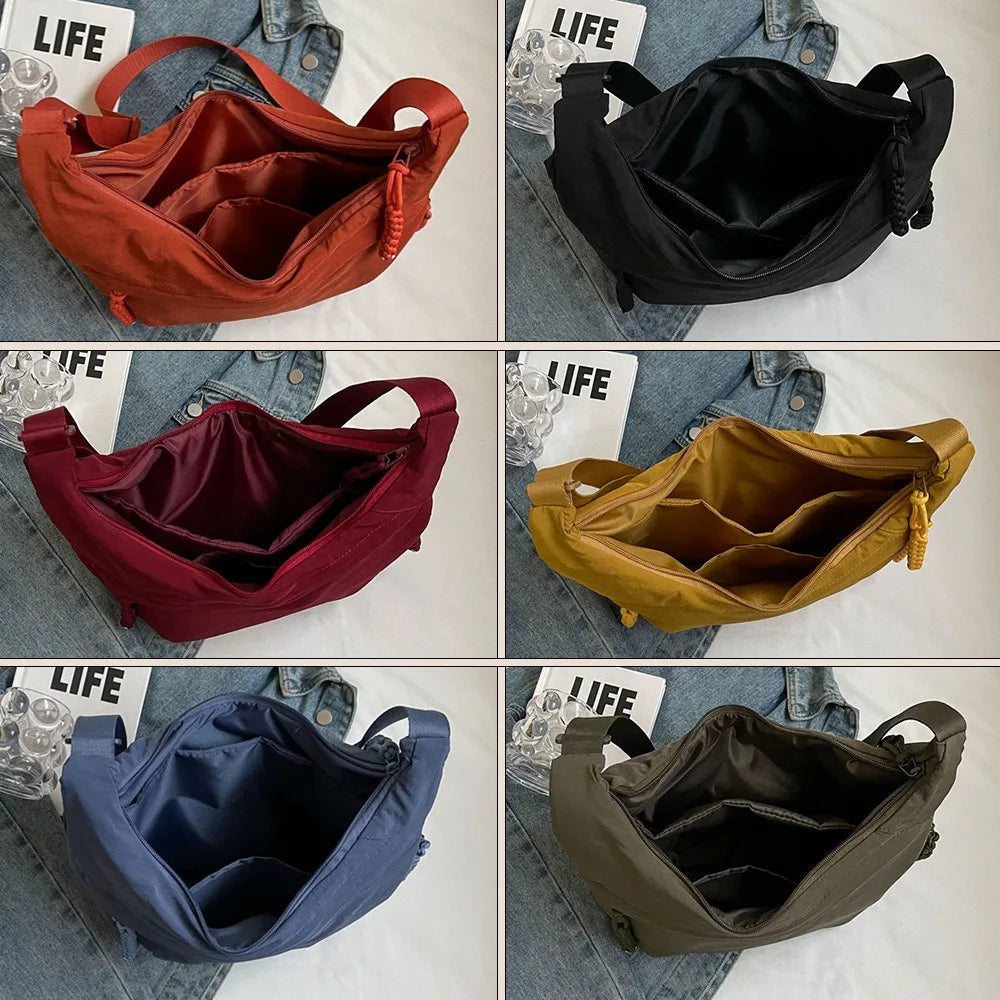 A collection of canvas crossbody bags in various colors including orange, black, maroon, yellow, blue, and olive green.