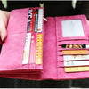 A pink PU leather clutch wallet with multiple card slots and RFID protection features is held in a hand.