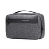 A dark gray travel toiletry organizer bag with a black handle and a slim black nameplate.