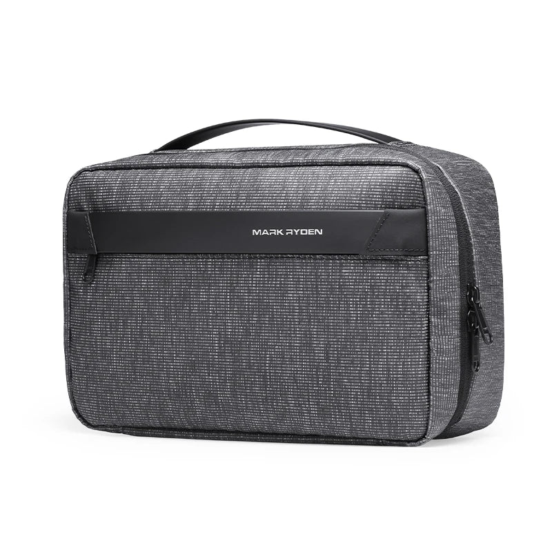 A dark gray travel toiletry organizer bag with a black handle and a slim black nameplate.