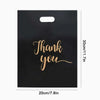 Black gift bag with gold script text that reads Thank you