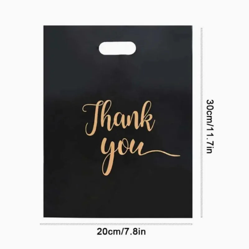 Black gift bag with gold script text that reads Thank you