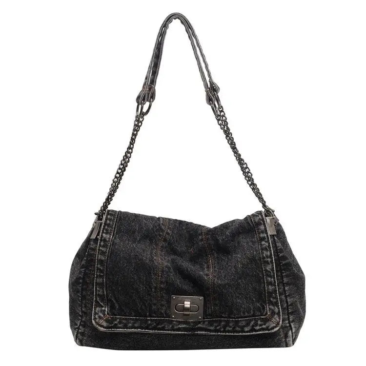A dark denim tote bag with a chain strap.