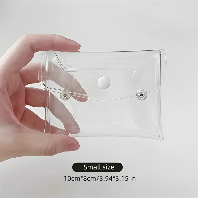 A hand holds a clear, transparent portable organizer pouch for cosmetics and tools.