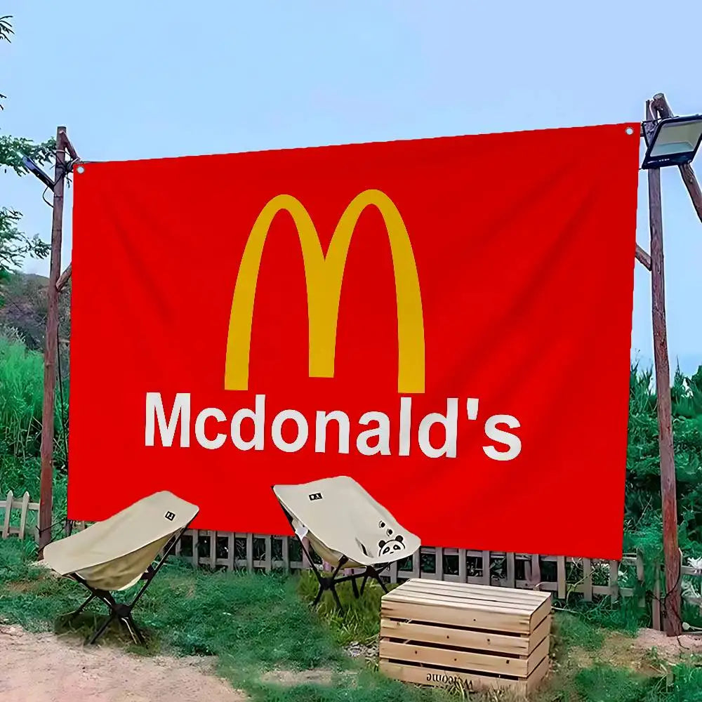 A large red banner featuring the McDonald's golden arches logo and the brand name in white text, set outdoors.