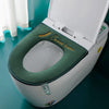 A white toilet seat cover with a green cushion and 'Sweet home' text is shown open on a toilet.
