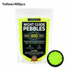 A sealed bag of yellow glow-in-the-dark pebbles for outdoor decoration.