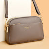 A brown PU leather trendy shoulder crossbody bag with gold hardware shown against a light background.