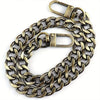 A close-up view of a brass metal chain strap used for handbags and wallets.