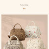 Two beige and brown floral corduroy insulated lunch bags displayed on a wooden surface.