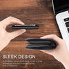 A hand holds a sleek black metal card holder wallet on a wooden desk next to a laptop.