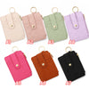 A set of seven pastel colored PU leather card holder wallets with gold rings and tassels