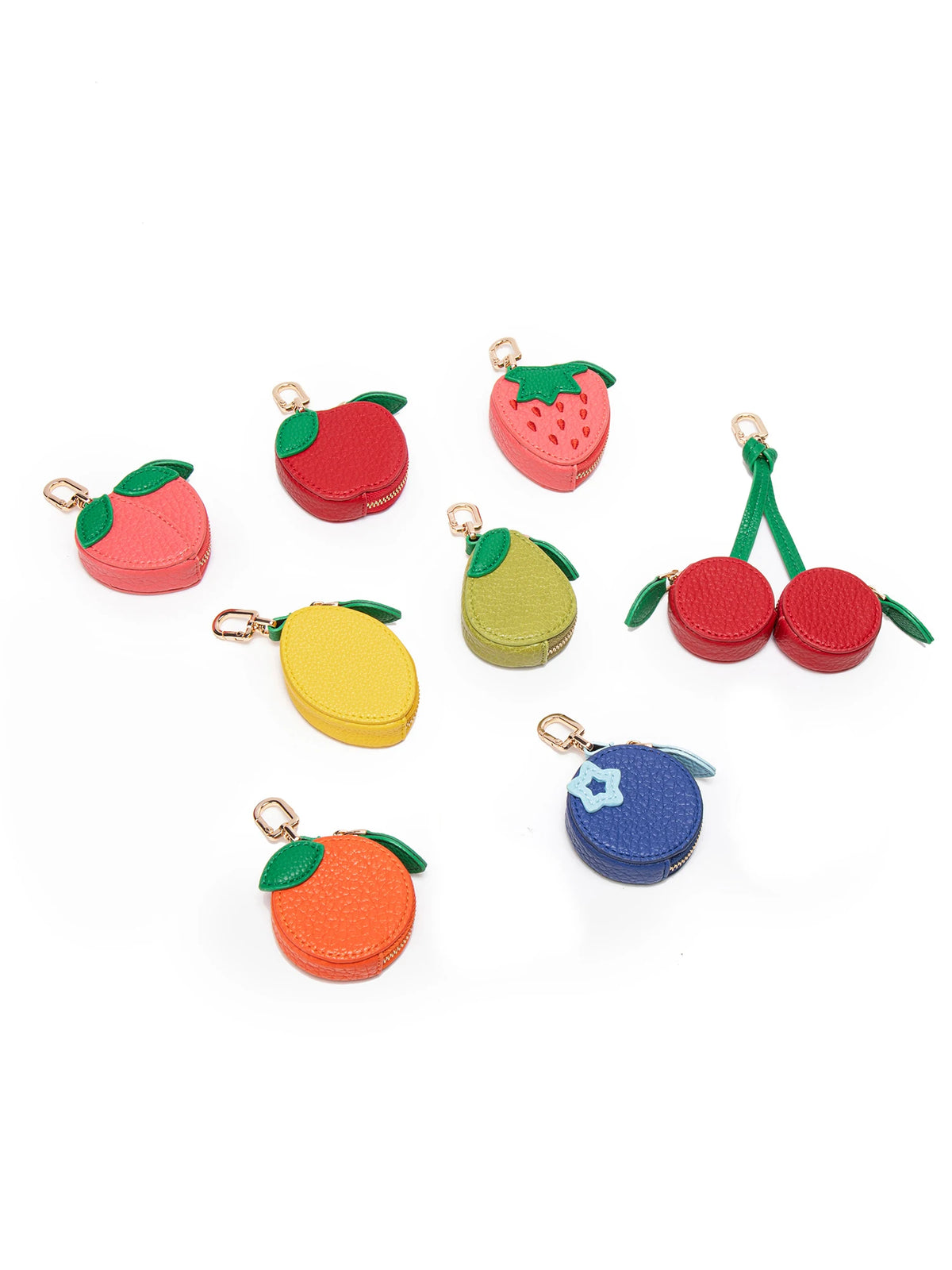 A collection of red and green fruit-shaped coin purse keychains featuring cherry, strawberry, and lime designs.