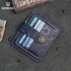 A dark blue genuine leather card wallet with a stitched edge and multiple cards resting on a gray fabric surface.
