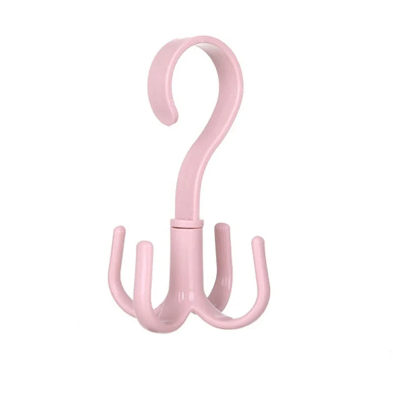 A pink four-claw multi-functional hanging hook with a curved handle.