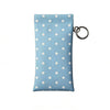 Light blue polka dot eyeglass pouch with a silver keychain attached.
