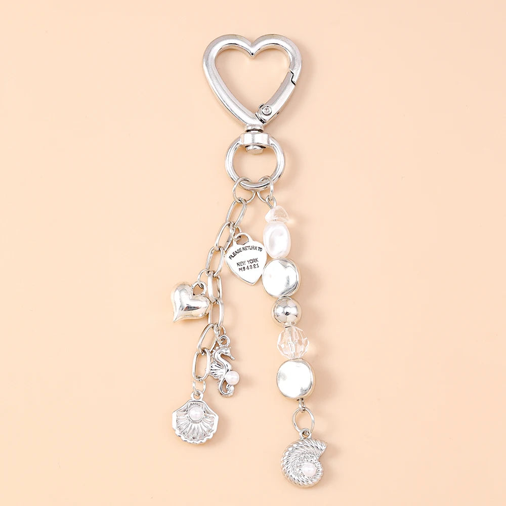 Silver starfish keychain with pearl accents and a heart charm