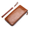 A brown PU leather men's clutch wallet with a leather strap and zipper visible on a white background.
