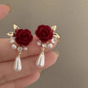 Gold-toned velvet rose earrings with pearl and diamond accents