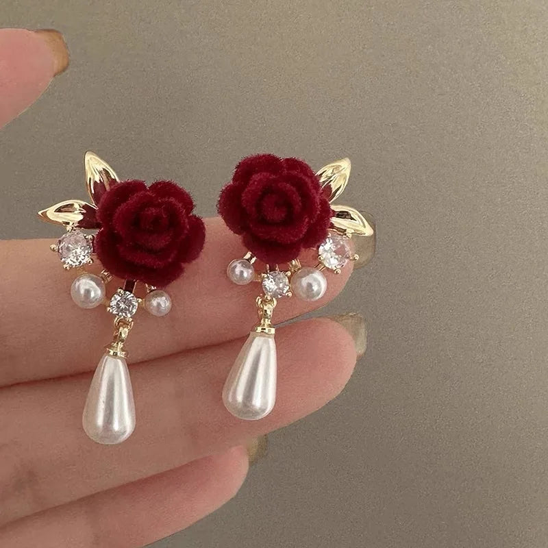 Gold-toned velvet rose earrings with pearl and diamond accents