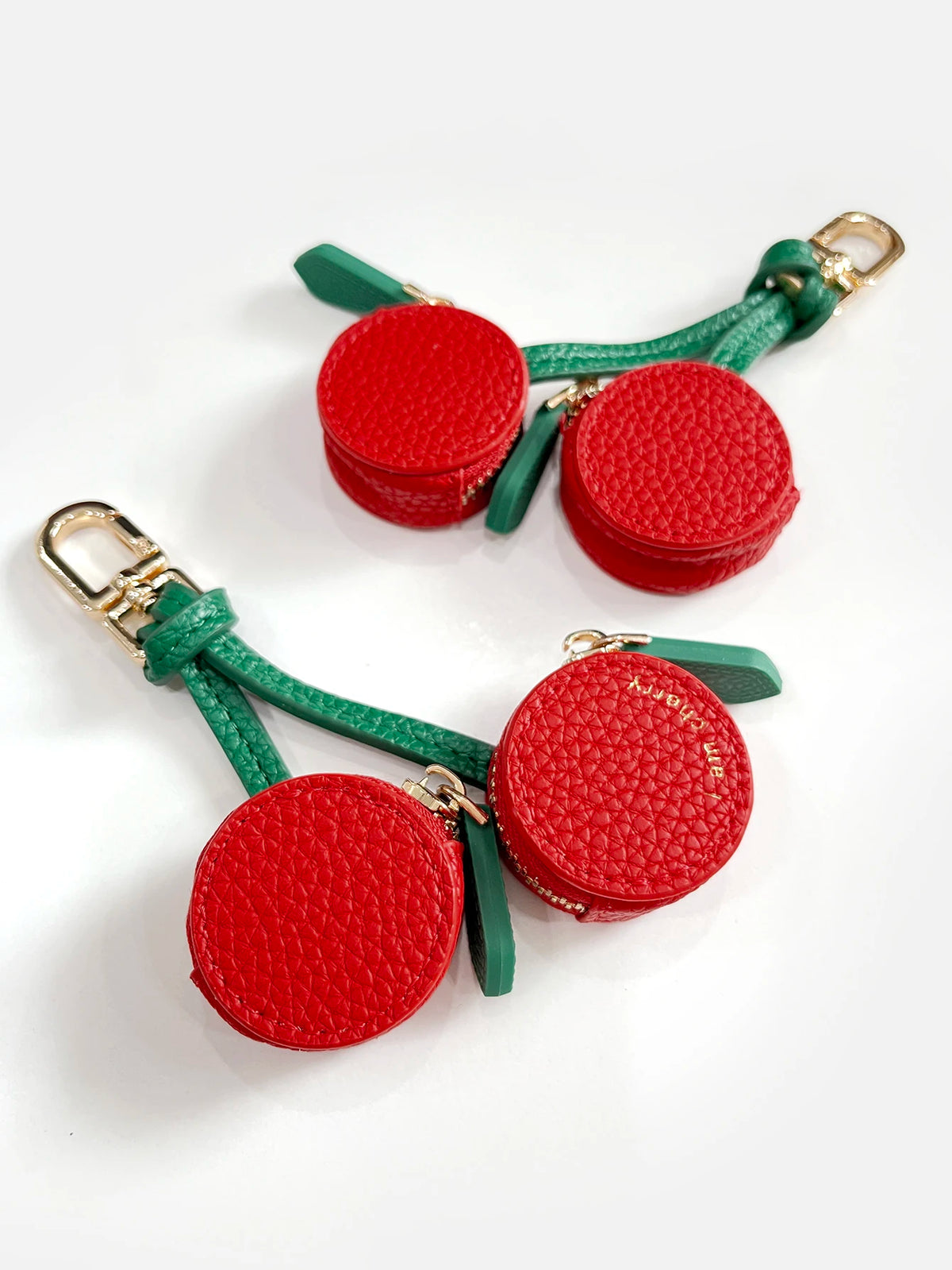Red cherry fruit shape coin purse keychain with green leather strap and gold clasp