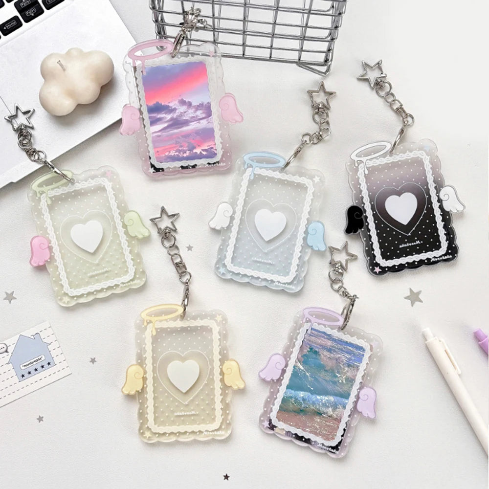 A collection of clear and colored acrylic photo card holders with angel wings and charms.