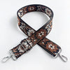 A close-up of a brown and cream patterned fabric strap for an adjustable crossbody bag.
