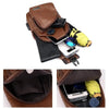 A brown leather crossbody chest bag with a USB charging port and various accessories visible inside.