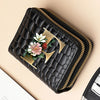 Black PU leather double-zip clutch wallet featuring a gold geometric design and floral print.