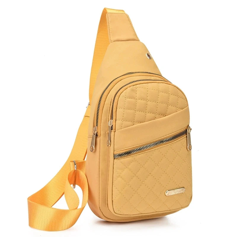 A tan quilted crossbody sling bag with a matching strap shown from the side.