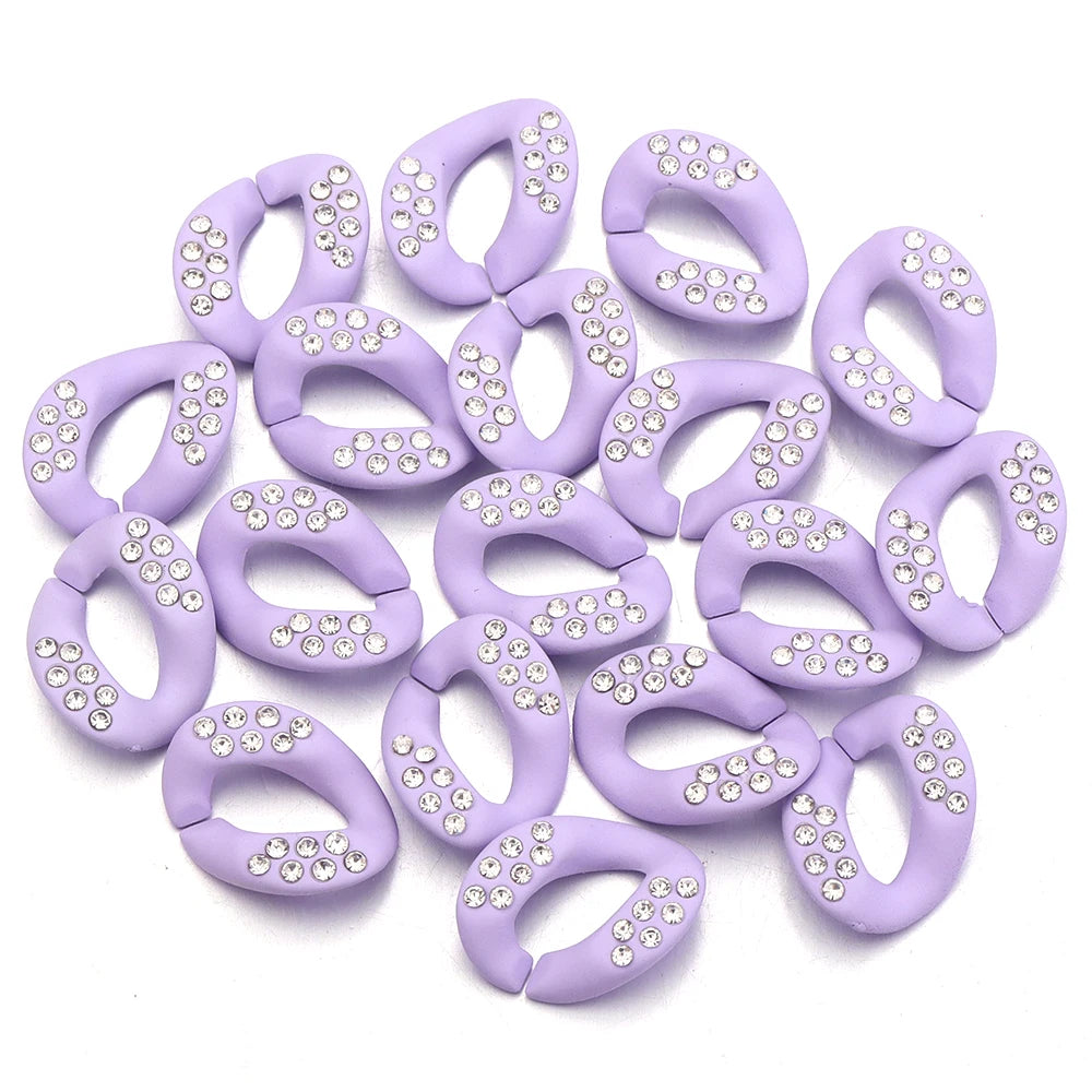 A collection of purple acrylic link chain connectors studded with clear rhinestones.