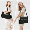 A woman is shown carrying a black insulated laptop lunch tote with a strap, next to a similar tote.