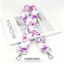 A pink and purple floral patterned nylon strap for bags and purses.
