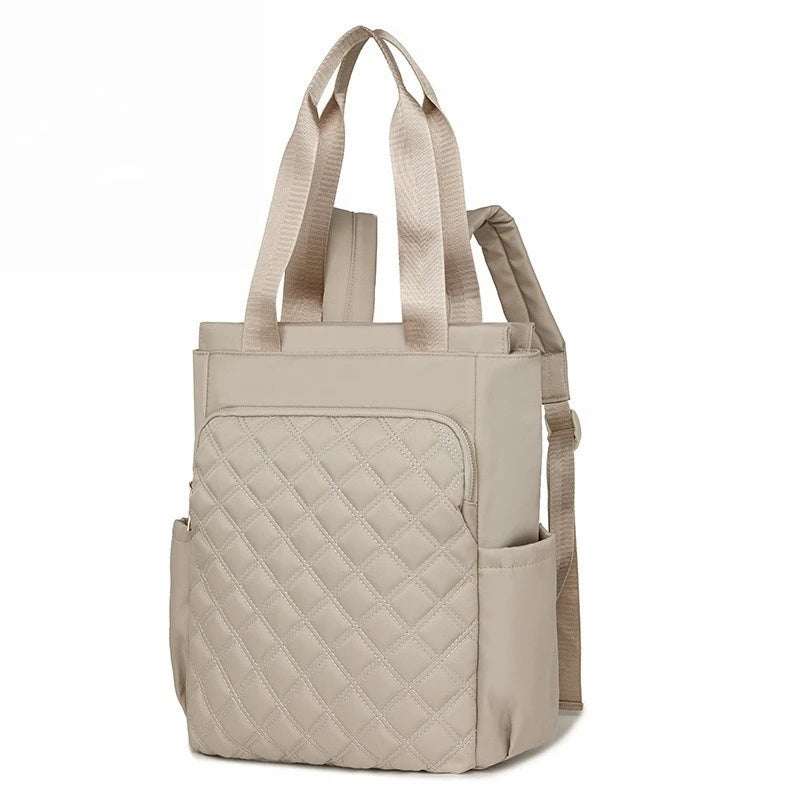A beige quilted women's backpack tote bag with padded straps.