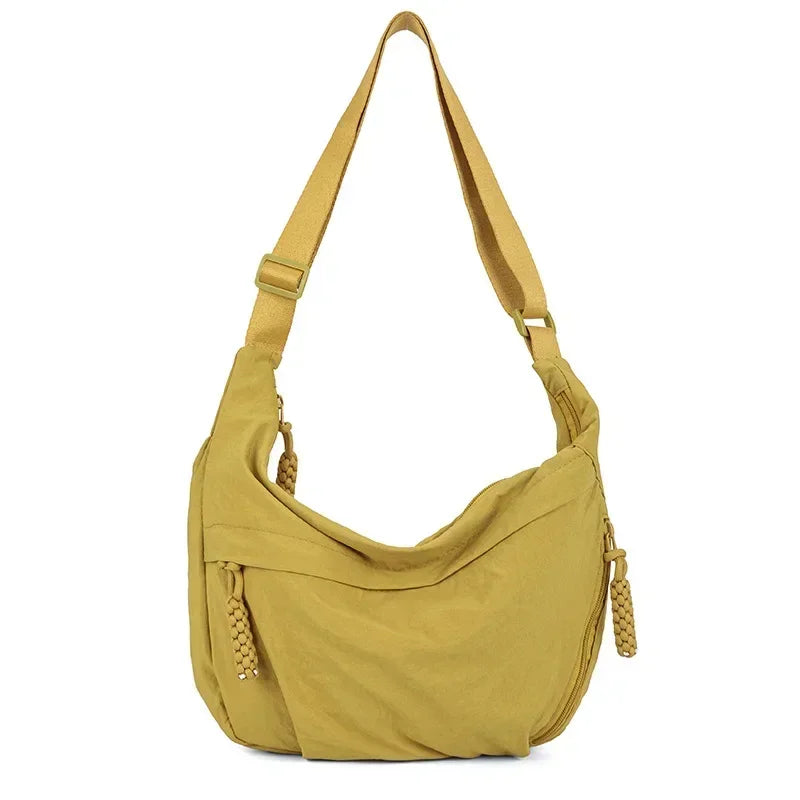 A mustard yellow soft nylon crossbody shoulder bag with adjustable straps.