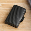 Black premium double layer ID card holder wallet with a textured pattern resting on a wooden surface.