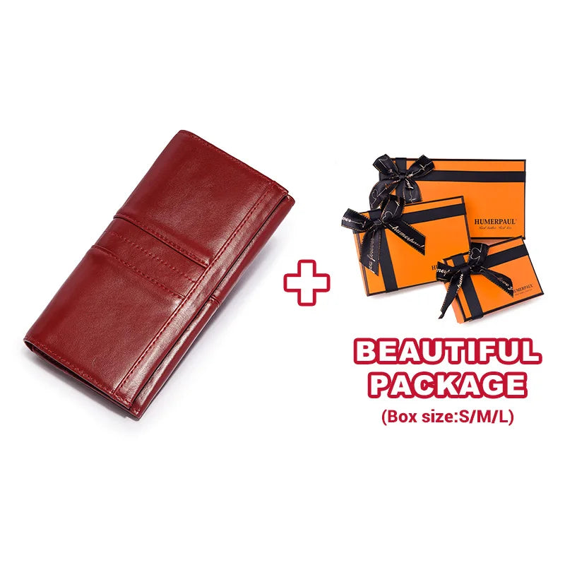 A maroon genuine leather clutch wallet is shown next to an orange gift box package.
