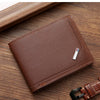 A brown leather wallet with a money clip is shown resting on a wooden surface.