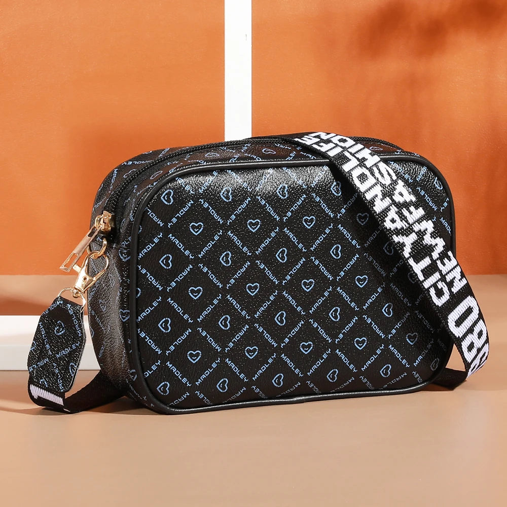 Black fashion crossbody shoulder bag with white text pattern on the fabric