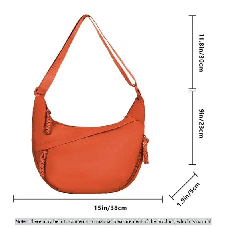 An orange soft nylon crossbody shoulder bag with an adjustable strap shown from the front and side.