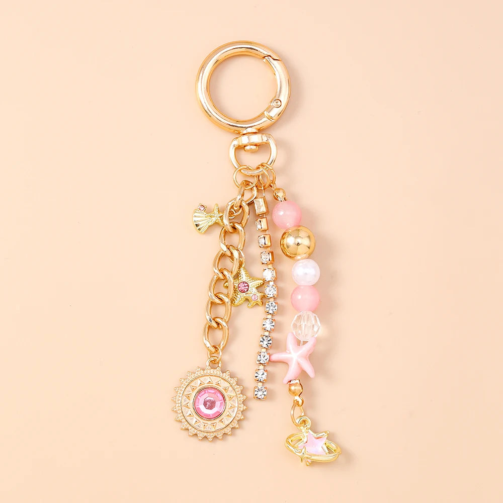 Gold seashell starfish keychain with pink and white pearl accents