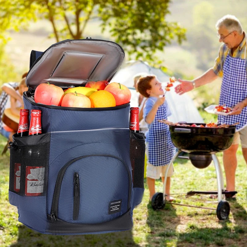 A blue insulated thermal cooler backpack is open, revealing fresh fruit, being used outdoors for a picnic.