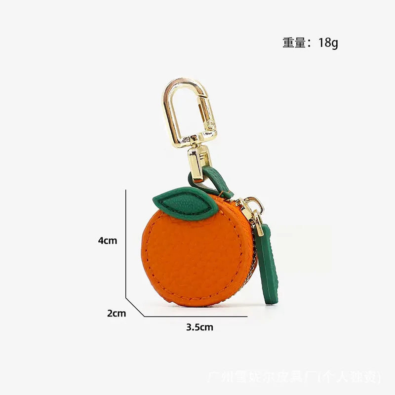 Orange fruit-shaped PU leather coin purse keychain with a gold-colored clasp