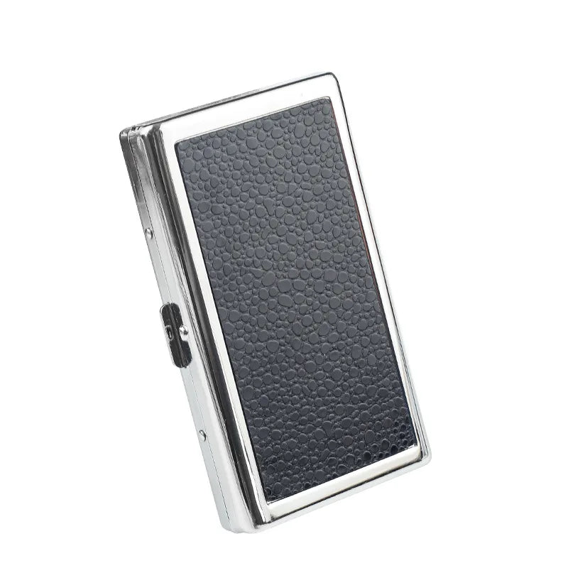 A silver metal cigarette case holder with a textured black surface.