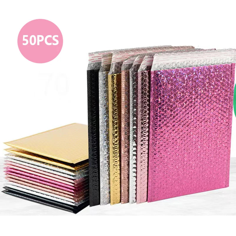 A stack of 50 holographic bubble mailers in various colors and finishes, including pink and gold.