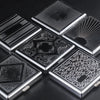 A collection of decorative metal cigarette storage boxes with intricate patterns and radiating designs.