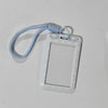 A clear card holder with a pink polka dot pattern and a light blue lanyard.