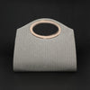 A light gray pleated circular evening handbag with a rose gold rim.